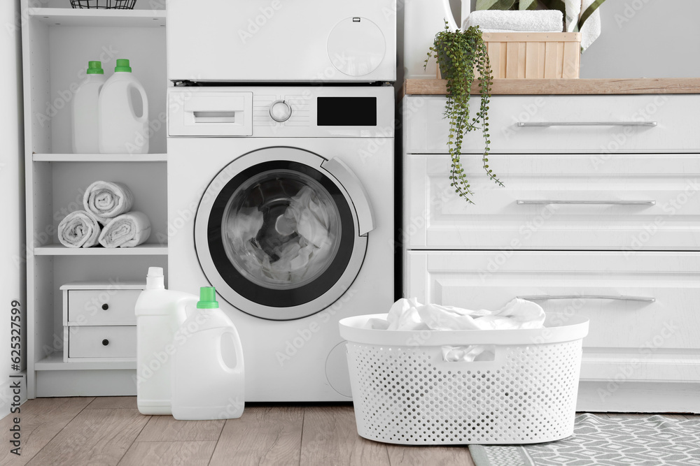 Laundry room with washing machine and white counters Laundry room with washing machine and white counters