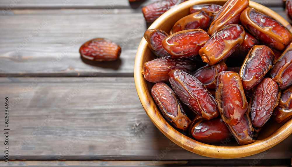 Dates or dattes palm fruit in wooden bowl is snack healthy. Dates or dattes palm fruit in wooden bowl is snack healthy.