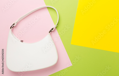 Trendy woman bag on colorful background, top view