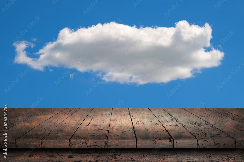 Wooden surface. Painted boards. Old table. Table surface. Wooden table against the background of a cloud on a blue sky