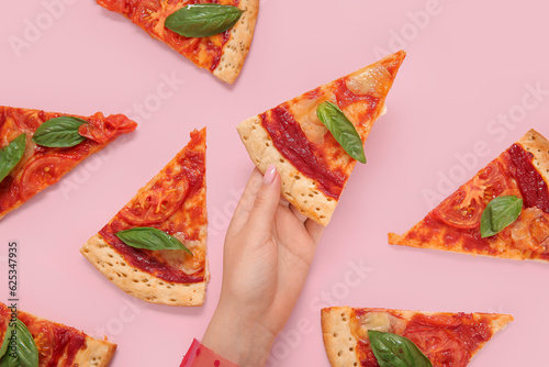 Woman with slices of tasty pizza on pink background