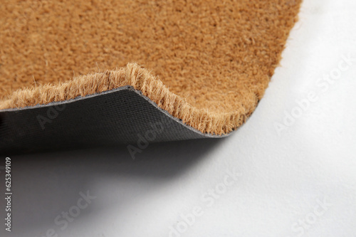 Natural brown coconut fiber doormat. Plain natural dry carpet and dirt outside your entrance, Detail, closeup of fiber and base on white background