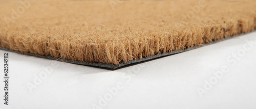Natural brown coconut fiber doormat. Plain natural dry carpet and dirt outside your entrance, Detail, closeup of fiber and base on white background