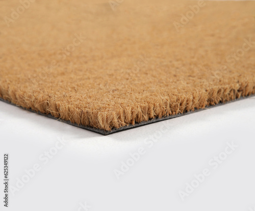Natural brown coconut fiber doormat. Plain natural dry carpet and dirt outside your entrance, Detail, closeup of fiber and base on white background