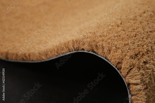 Natural brown coconut fiber doormat. Plain natural dry carpet and dirt outside your entryway, Fiber detail, closeup.