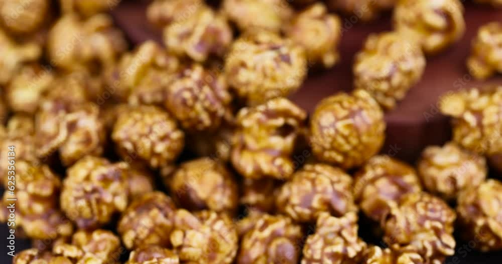 focus on delicious sweet popcorn with lots of caramel, caramel flavor of popcorn close-up focus on delicious sweet popcorn with lots of caramel, caramel flavor of popcorn close-up