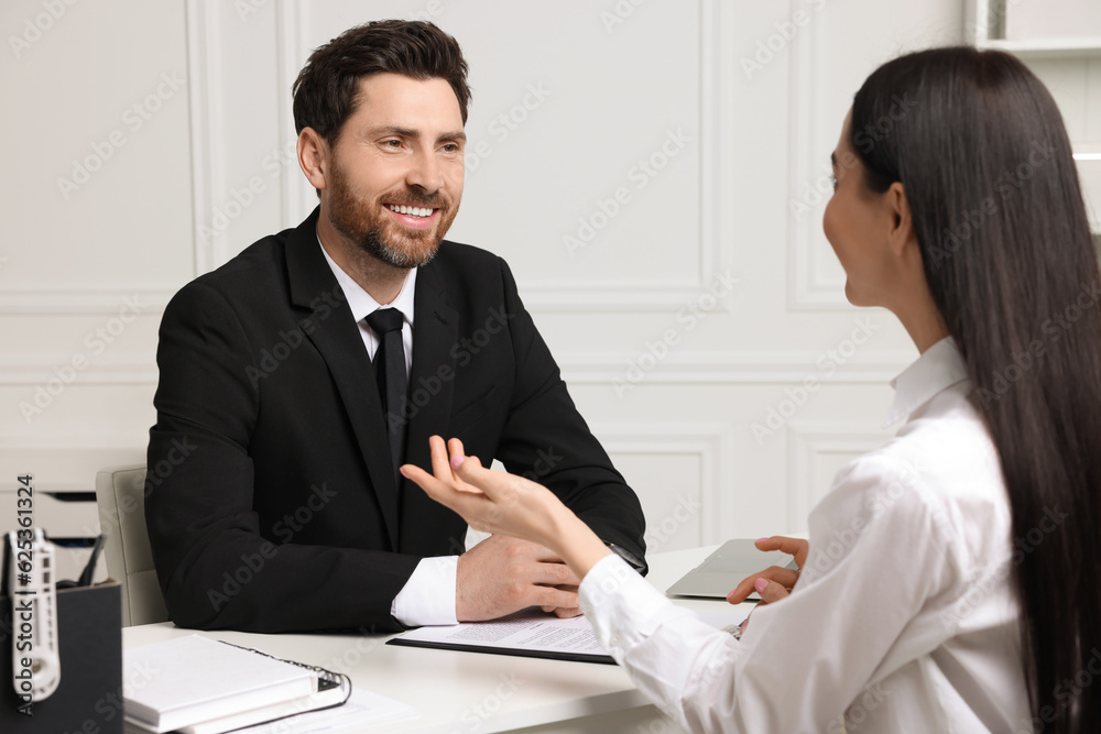 Human resources manager conducting job interview with applicant in office Human resources manager conducting job interview with applicant in office