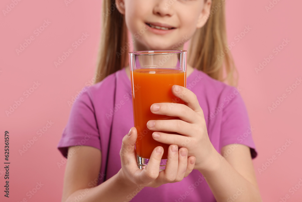Cute little girl with glass of fresh juice on pink background, closeup Cute little girl with glass of fresh juice on pink background, closeup
