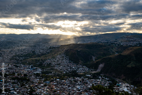 Panoramic View of Tegucigalpa City with Hills  Houses  Buildings  and Trees Surrounded by Green Mountains on a Cloudy Day