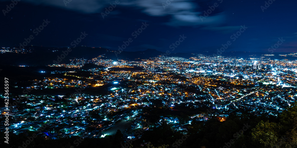 Wide Panoramic Colorful Tegucigalpa Night Cityscape Long Exposure Shot With Blurred Clouds