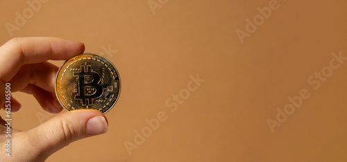 Female hands holding Bitcoin gold coin. Bitcoin mining trading concept. BTC golden money spinning around. Worldwide virtual internet Cryptocurrency or crypto digital payment system. Digital coin money photo