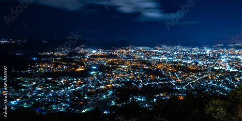 Obraz na płótnie Wide Panoramic Colorful Tegucigalpa Night Cityscape Long Exposure Shot With Blurred Clouds w salonie