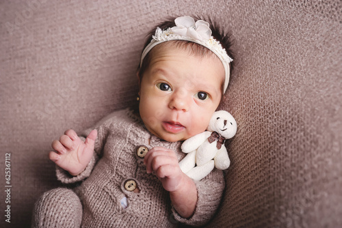 newborn baby girl posing and smiling