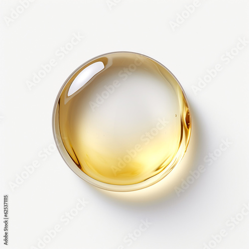 Drop of golden oil isolated on white background photo