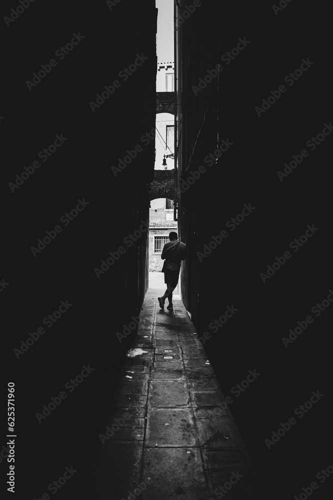 silhouette of a person in the alley