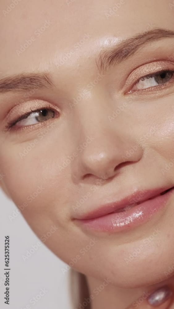 Vertical video. Skin nourishment. Cosmetology skincare. Facial wellness. Beautiful woman with nude makeup touching enjoying soft moisturized face. Vertical video. Skin nourishment. Cosmetology skincare. Facial wellness. Beautiful woman with nude makeup touching enjoying soft moisturized face.