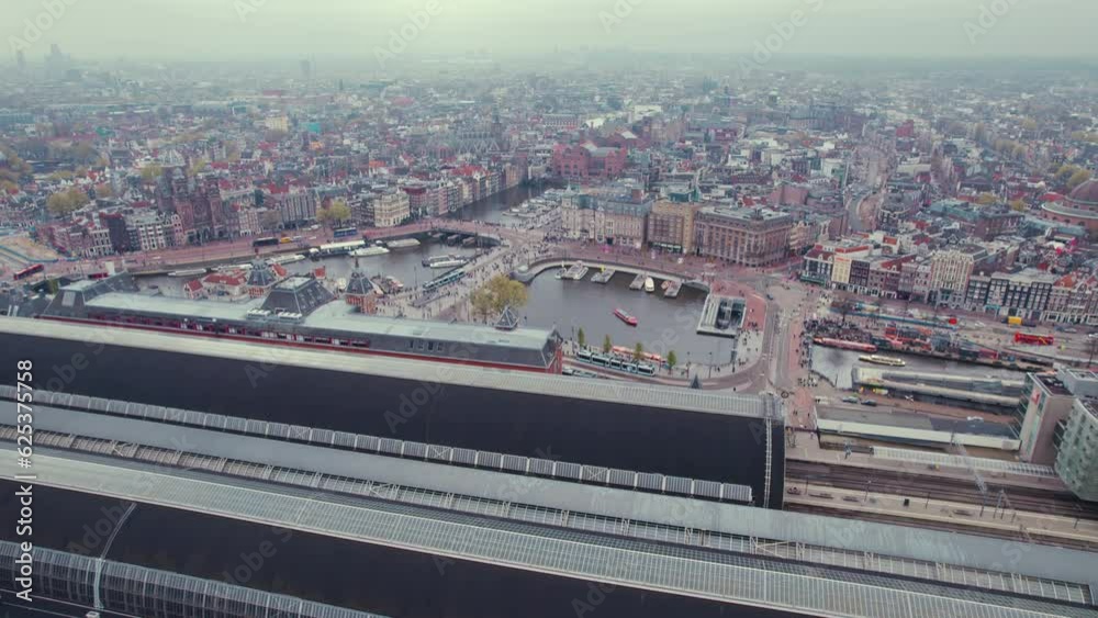 Aerial panorama of Amsterdam Centraal Central Railway Station by the river IJ, Netherlands. High quality 4k footage