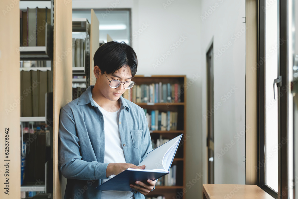 University students reading books in library for research. University students reading books in library for research.