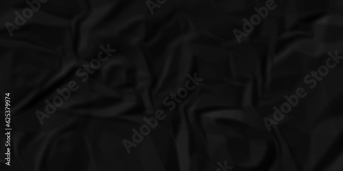 Black fabric background. Black crumpled  and wrinkled paper texture crush paper so that it becomes creased and wrinkled. Old black crumpled paper sheet background texture. 	