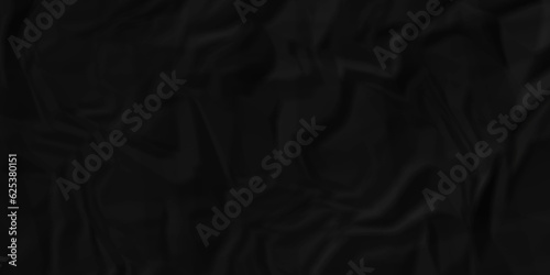 Black crumpled  and wrinkled paper texture crush paper so that it becomes creased and wrinkled. Old black crumpled paper sheet background texture. 	