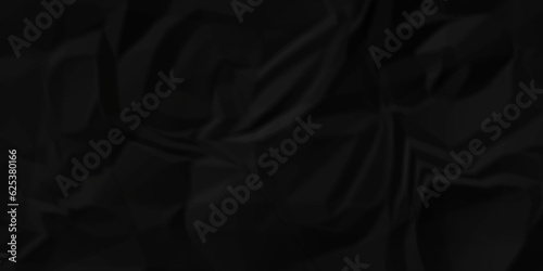 Black fabric background. Black crumpled  and wrinkled paper texture crush paper so that it becomes creased and wrinkled. Old black crumpled paper sheet background texture. 	