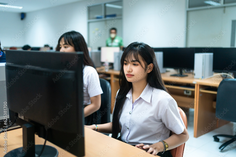 Asian girls students studying computer subject in computer classroom Asian girls students studying computer subject in computer classroom