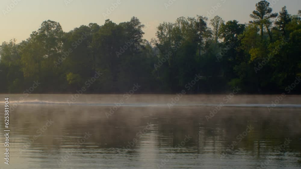 Canoe speeding over a foggy river in the morning - New River Blacksburg Virginia Canoe speeding over a foggy river in the morning - New River Blacksburg Virginia
