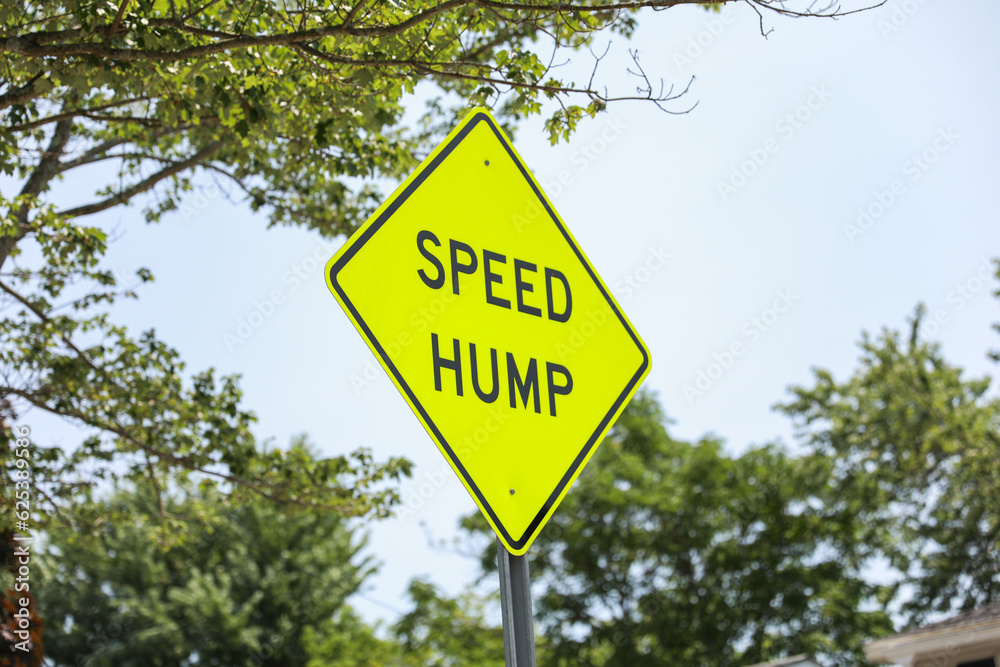 speed bump on a street symbolizes traffic control, caution, and slowing down for safety. It represents the need to be vigilant and considerate of others