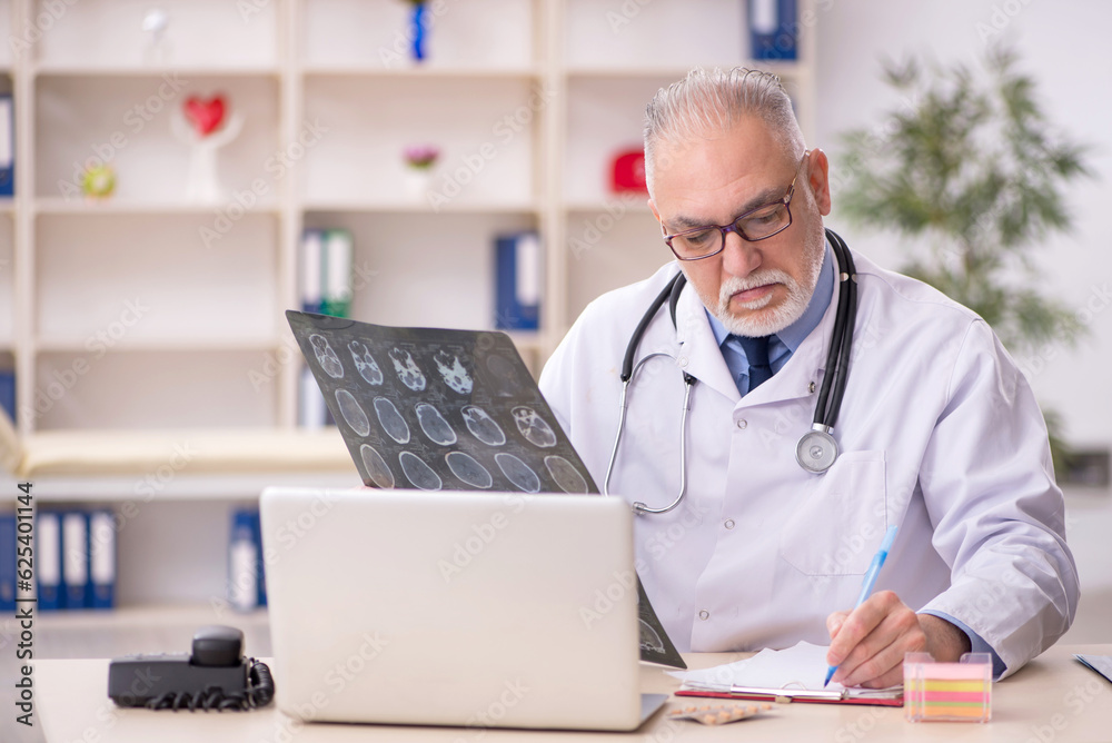 Old male doctor radiologist working in the clinic Old male doctor radiologist working in the clinic