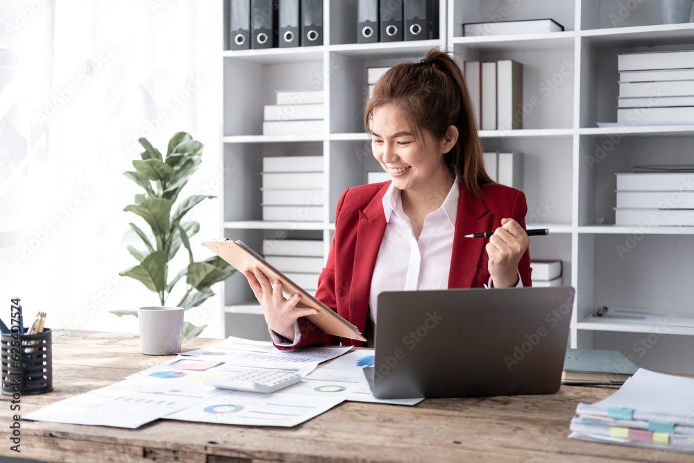Smiling confident successful businesswoman leader happy moment about her work, attractive young Asian accountant female joyful smiling while working in office Smiling confident successful businesswoman leader happy moment about her work, attractive young Asian accountant female joyful smiling while working in office