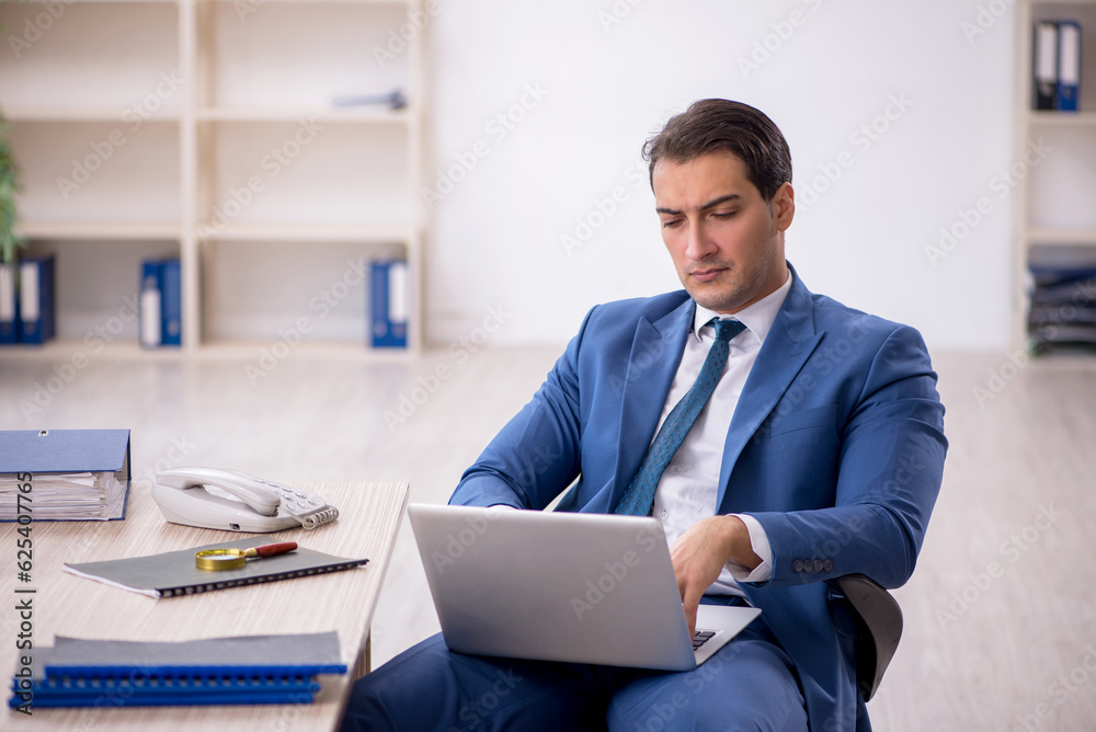 Young male employee working in the office Young male employee working in the office