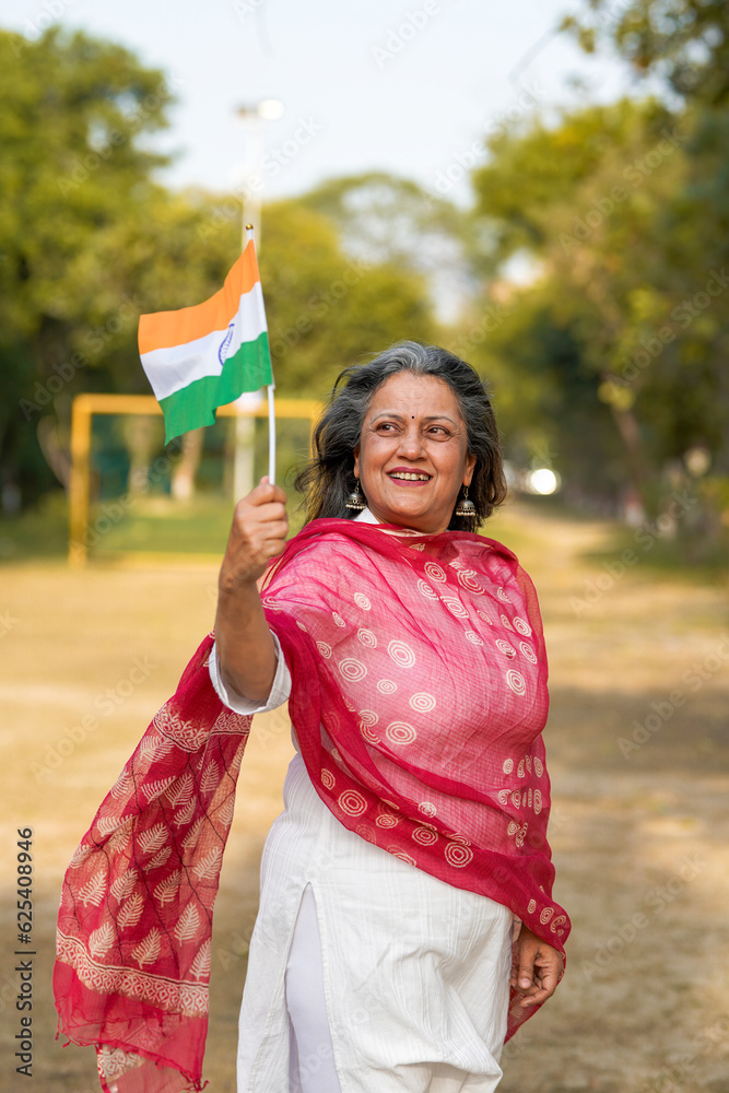 Indian woman waving national tricolor flag.