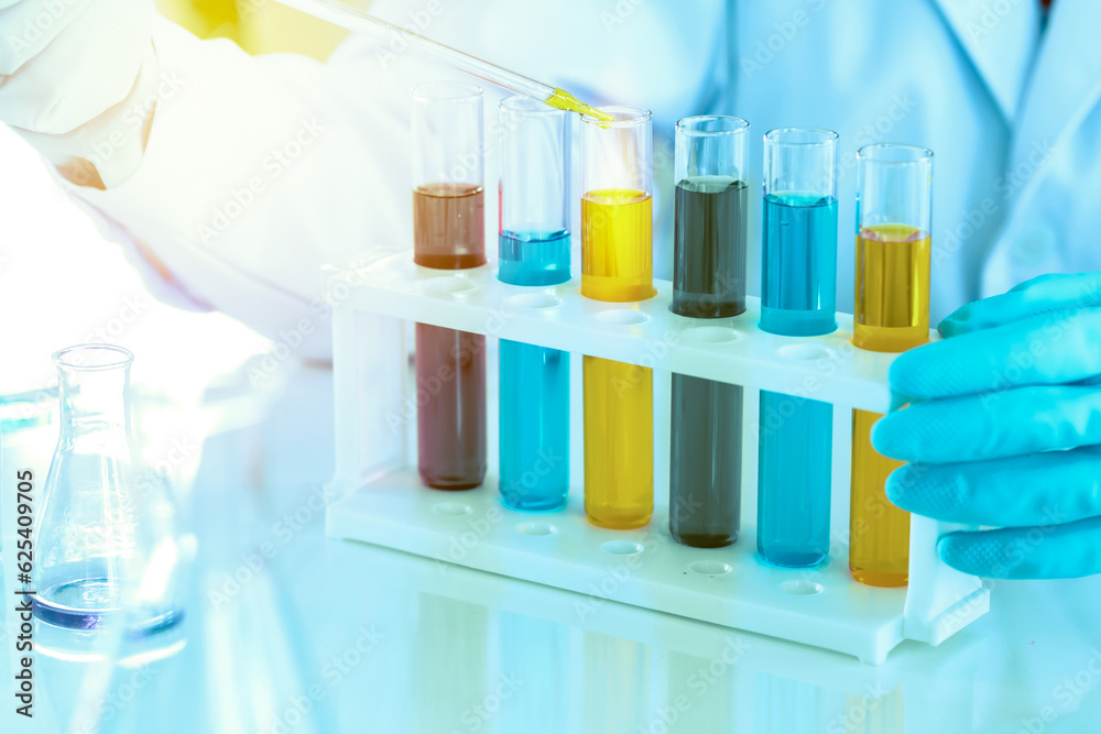 scientist with equipment and science experiments, laboratory glassware containing chemical liquid for research or analyzing a sample into test tube in laboratory scientist with equipment and science experiments, laboratory glassware containing chemical liquid for research or analyzing a sample into test tube in laboratory