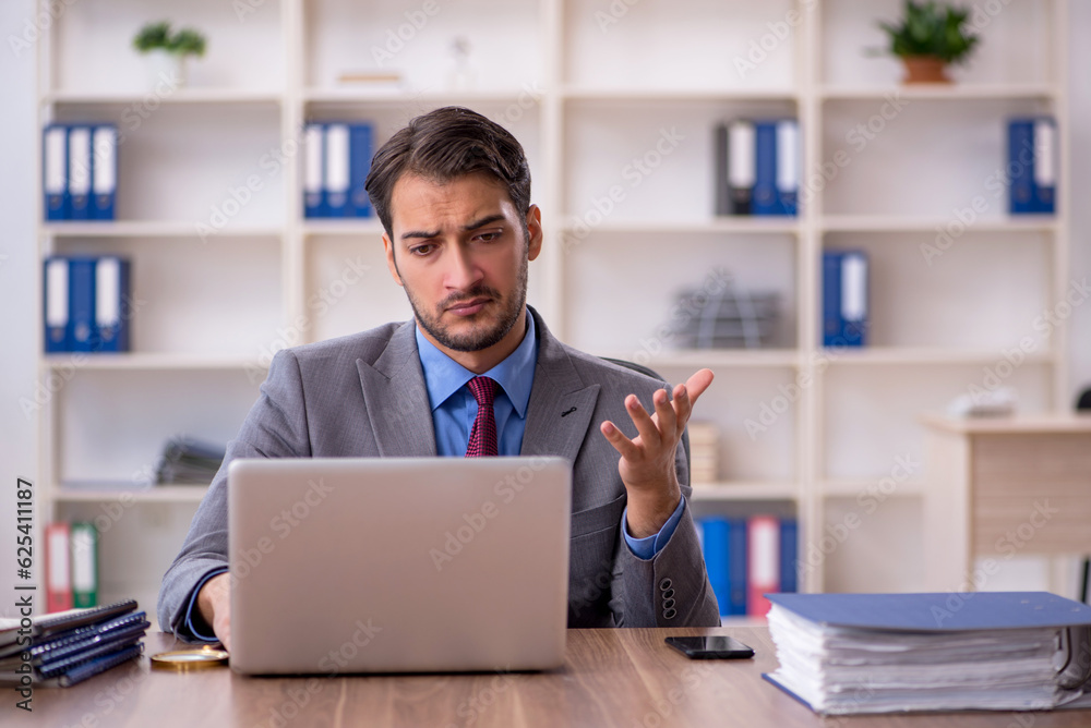 Young male employee working in the office Young male employee working in the office