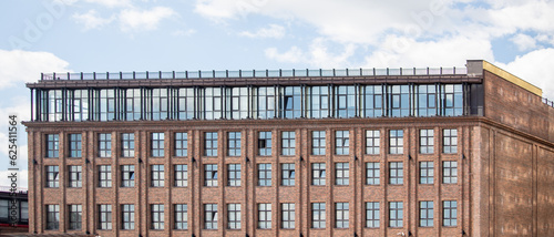 Multi-storey red brick houses against the sky.