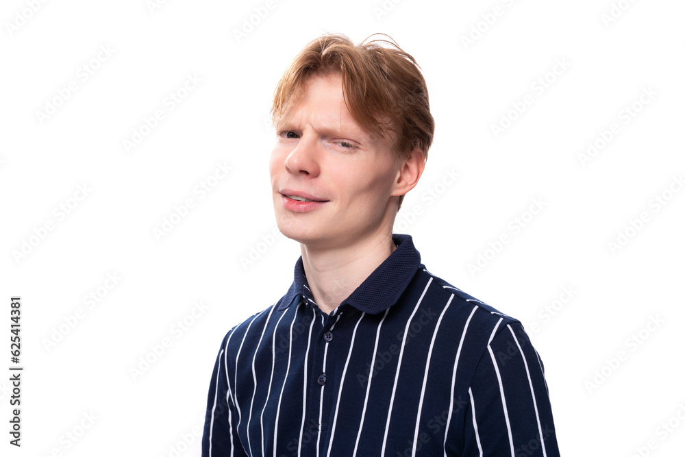 portrait of a well-groomed handsome European 25s blond man in a blue polo portrait of a well-groomed handsome European 25s blond man in a blue polo