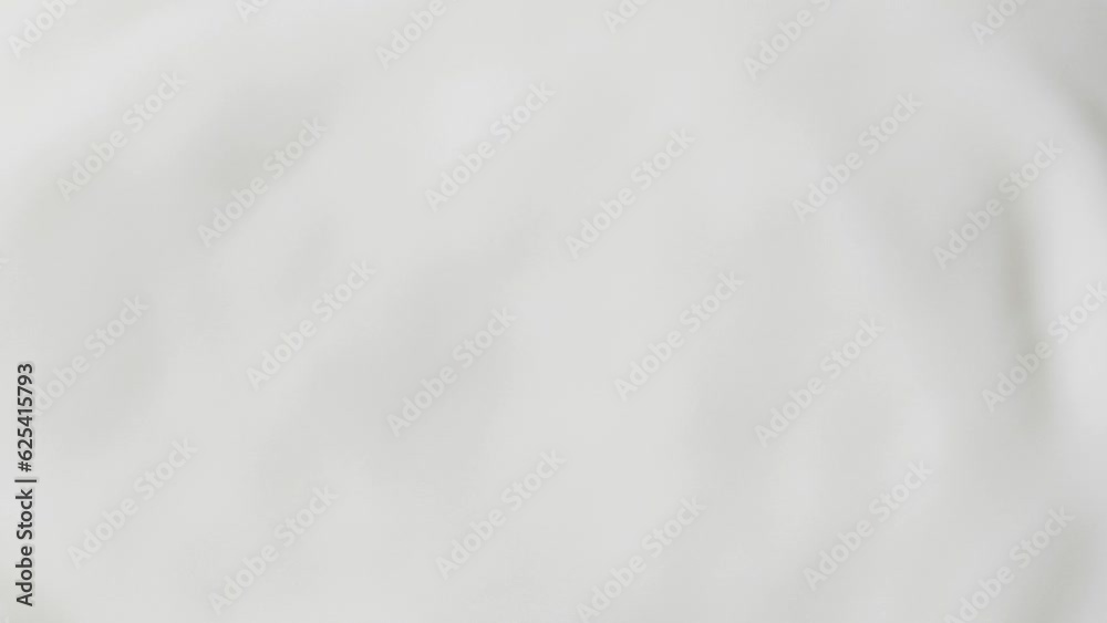 Slow motion white liquid cream ripples, close-up fresh milk drink splash texture