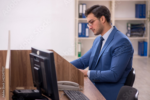 Young male employee working in the office