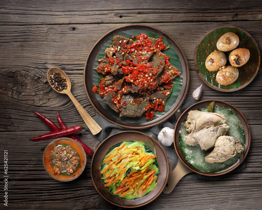 Some of the foods served on the table are beef jerky, eggs, boiled chicken, vegetables, chili sauce and spices. Some of the foods served on the table are beef jerky, eggs, boiled chicken, vegetables, chili sauce and spices.