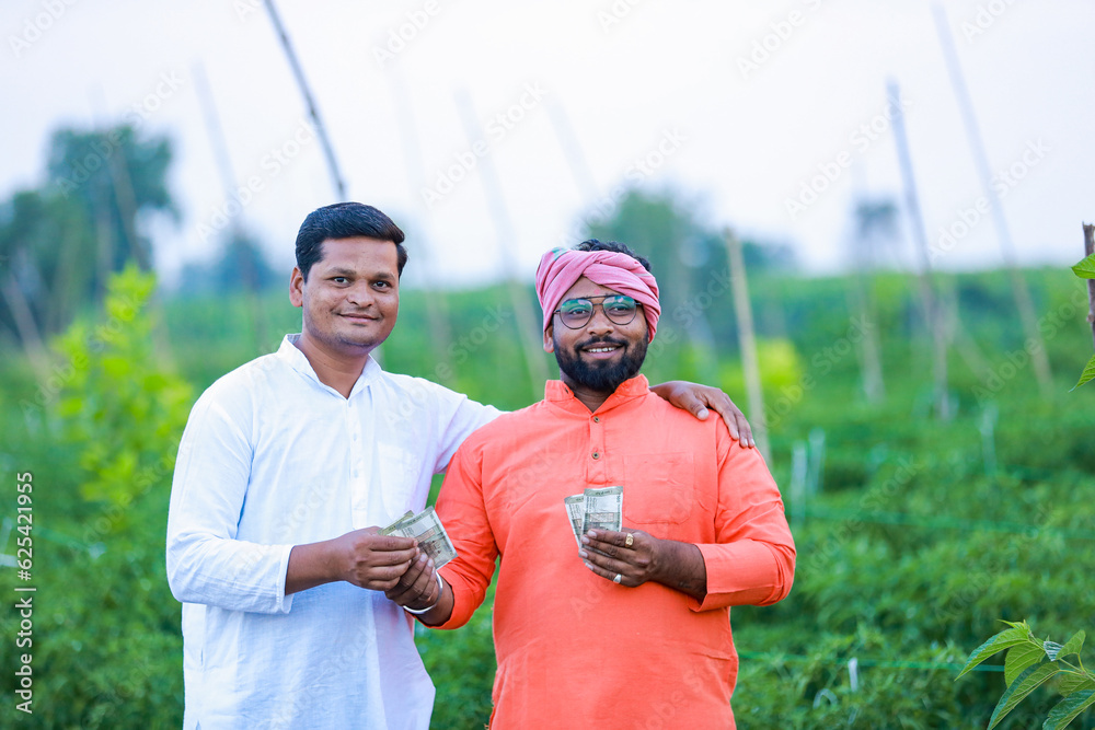 Indian farmer giving money to his worker