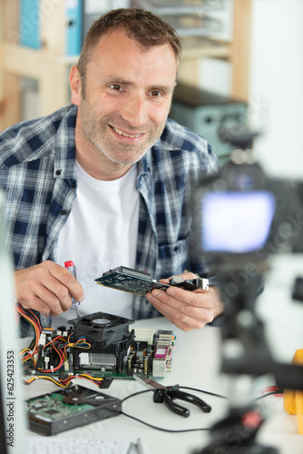 happy man filming himself fixing a drone