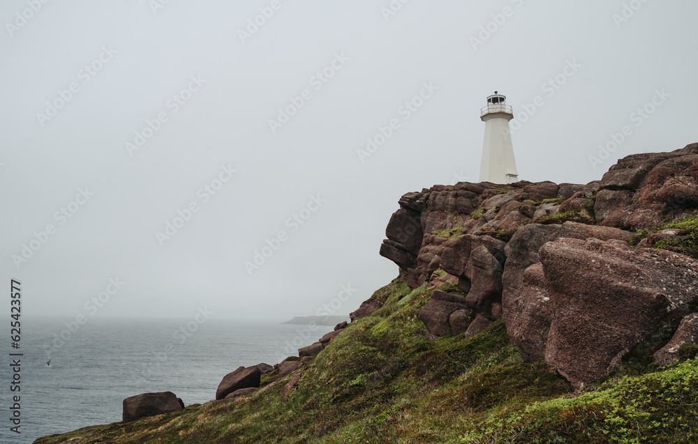 Lighthouse at Cape Spear, Newfoundland on cloudy day.