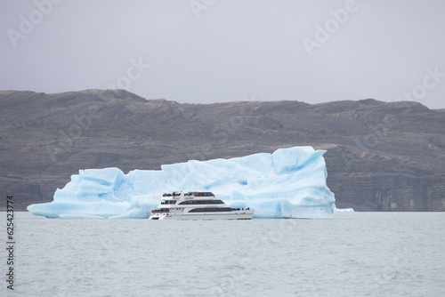 tourist ship close to iceberg photo