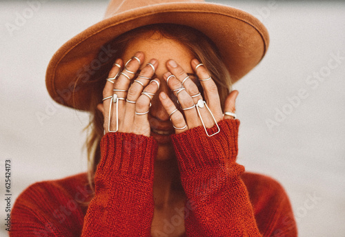 Young Woman Covering Face with Hands in Silver Ring Splints photo