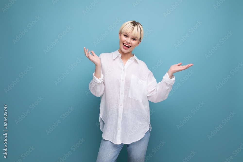 young charming pleasant pretty caucasian office worker woman with short blond hair is dressed in a white blouse on a background with copy space. business concept young charming pleasant pretty caucasian office worker woman with short blond hair is dressed in a white blouse on a background with copy space. business concept