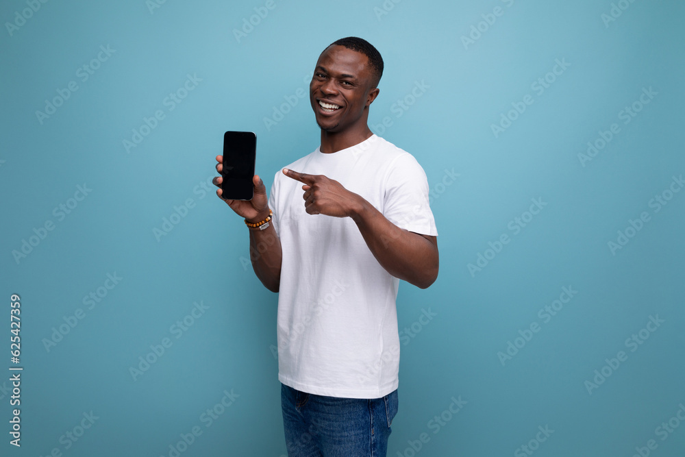 smiling 30 year old american male adult manager in white t-shirt showing smartphone screen smiling 30 year old american male adult manager in white t-shirt showing smartphone screen