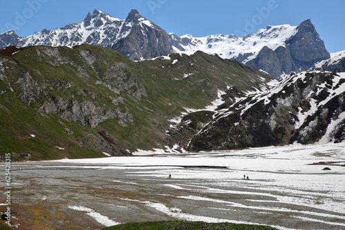 The lac de la Gliere (Gliere lake) located at the end of the valley of Champagny le Haut, Vanoise National Park, Northern French Alps, Tarentaise, Savoie, France, and surrounded by mountains  photo