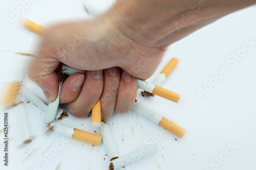 Man hand crushed cigarettes, trying to give up smoking