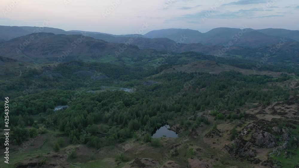 Aerial flight slowly descending onto Holme Fell at sunset. Aerial flight slowly descending onto Holme Fell at sunset.