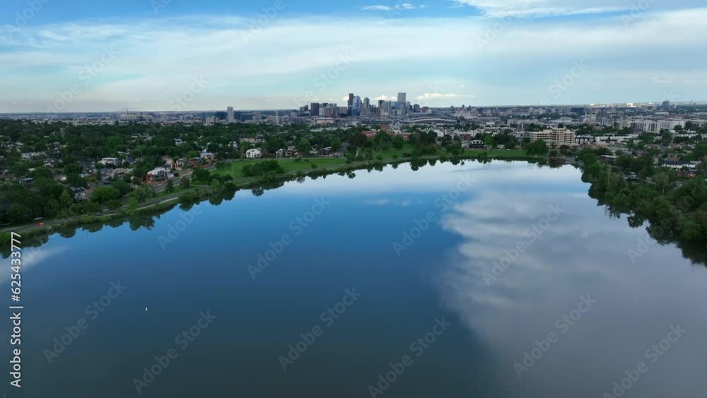 Wide shot of Denver, Colorado skyline from Sloans Lake. Aerial rising shot of beautiful city park in summer. Wide shot of Denver, Colorado skyline from Sloans Lake. Aerial rising shot of beautiful city park in summer.